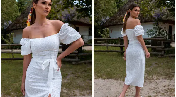 Biała sukienka hiszpanka z haftem, idealna na wesele plus size. Krój podkreślający sylwetkę, z falbankami na rękawach i rozcięciem.